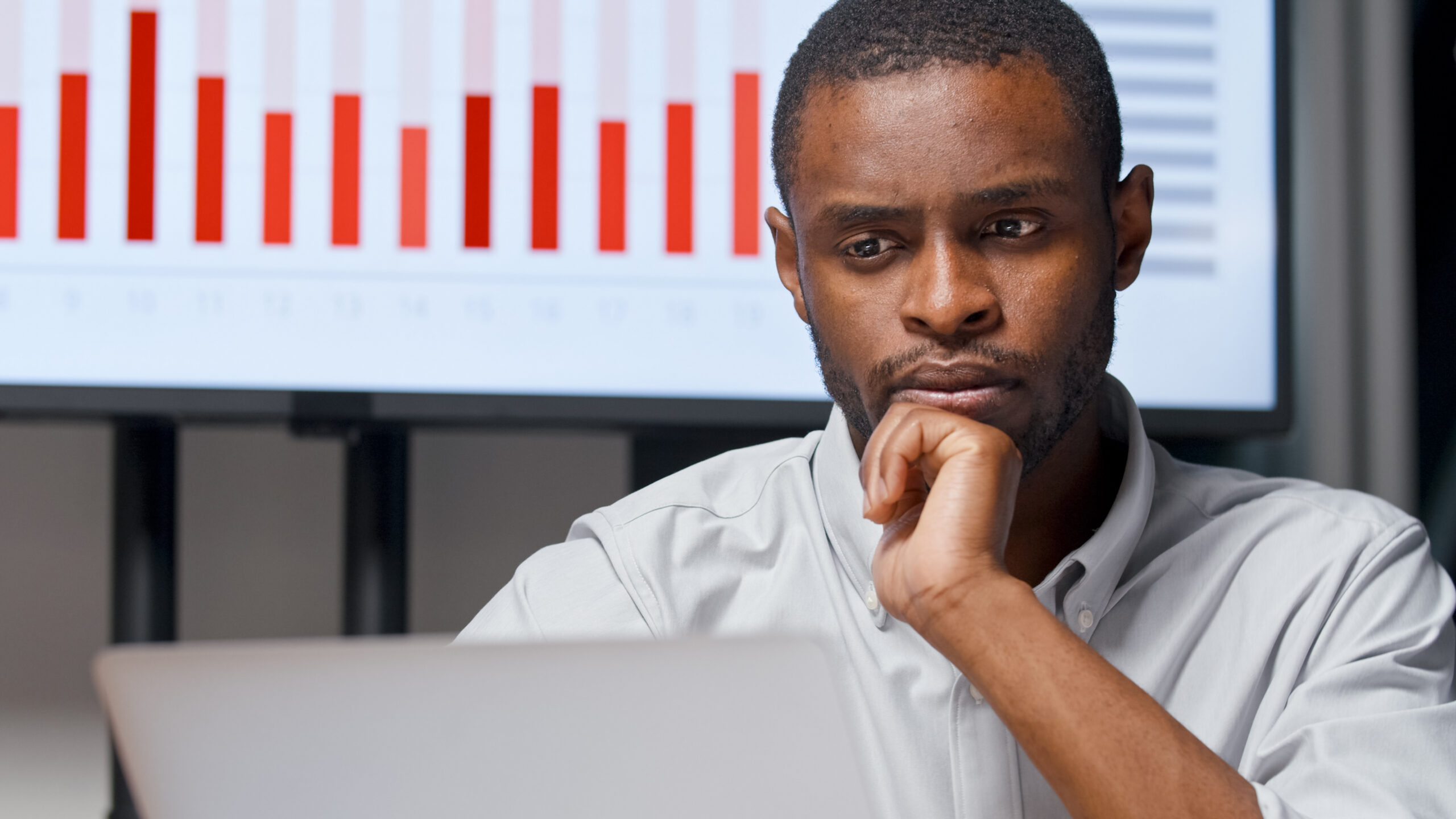 Business people: young businessman with a financial report in office