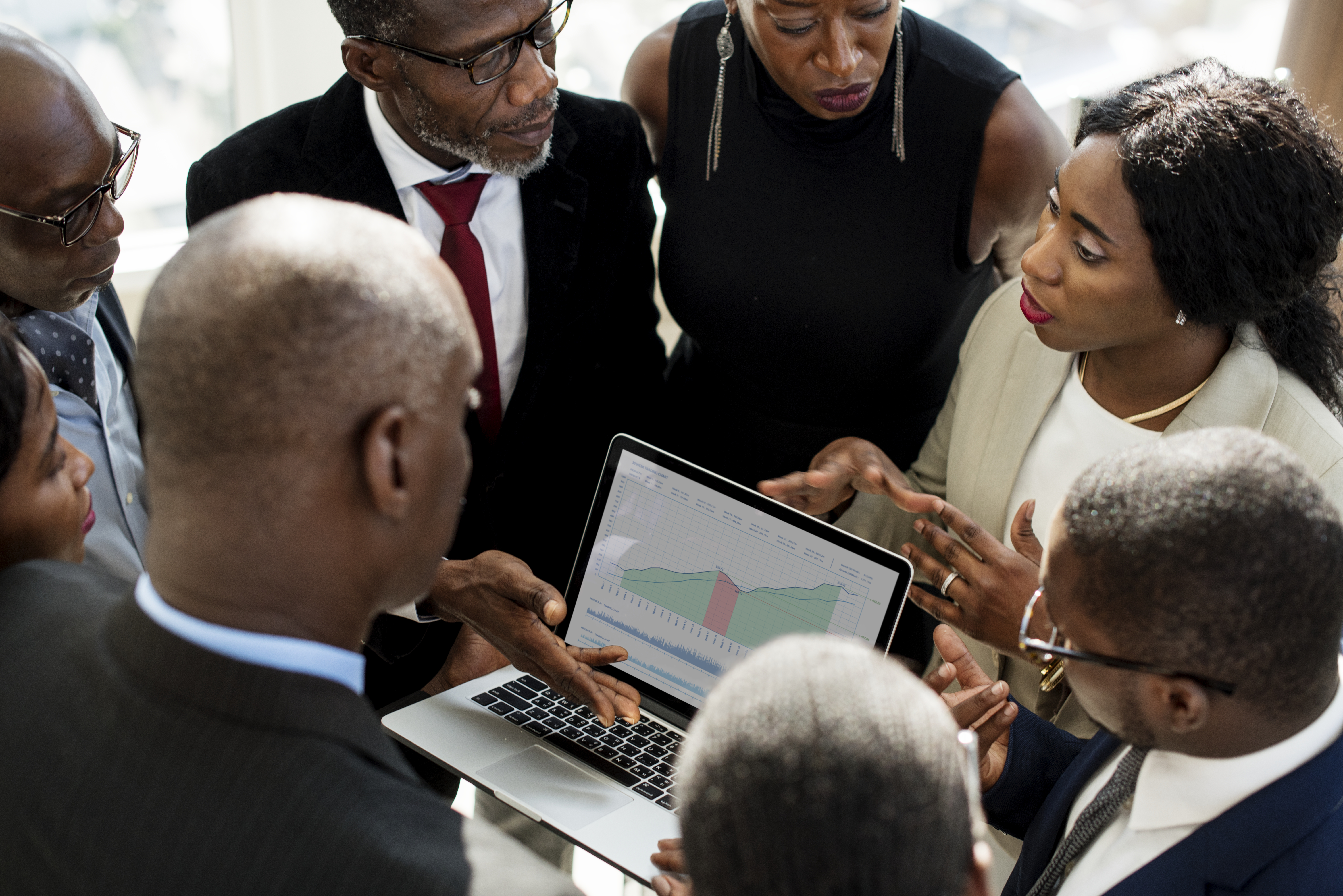 A Group of International Business People Are Having a Discussion with a Laptop