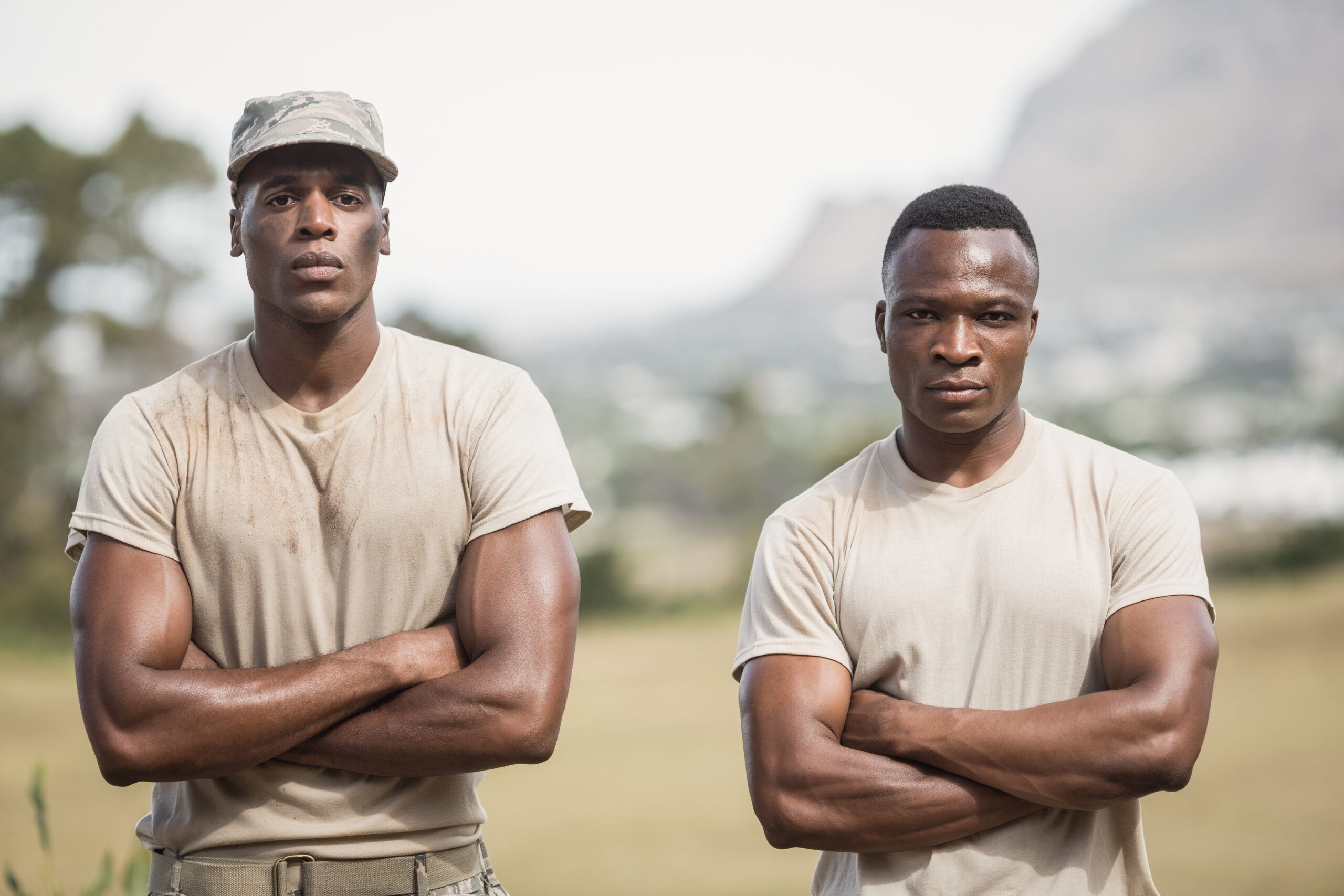 Military soldiers standing with arms crossed during obstacle course in boot camp