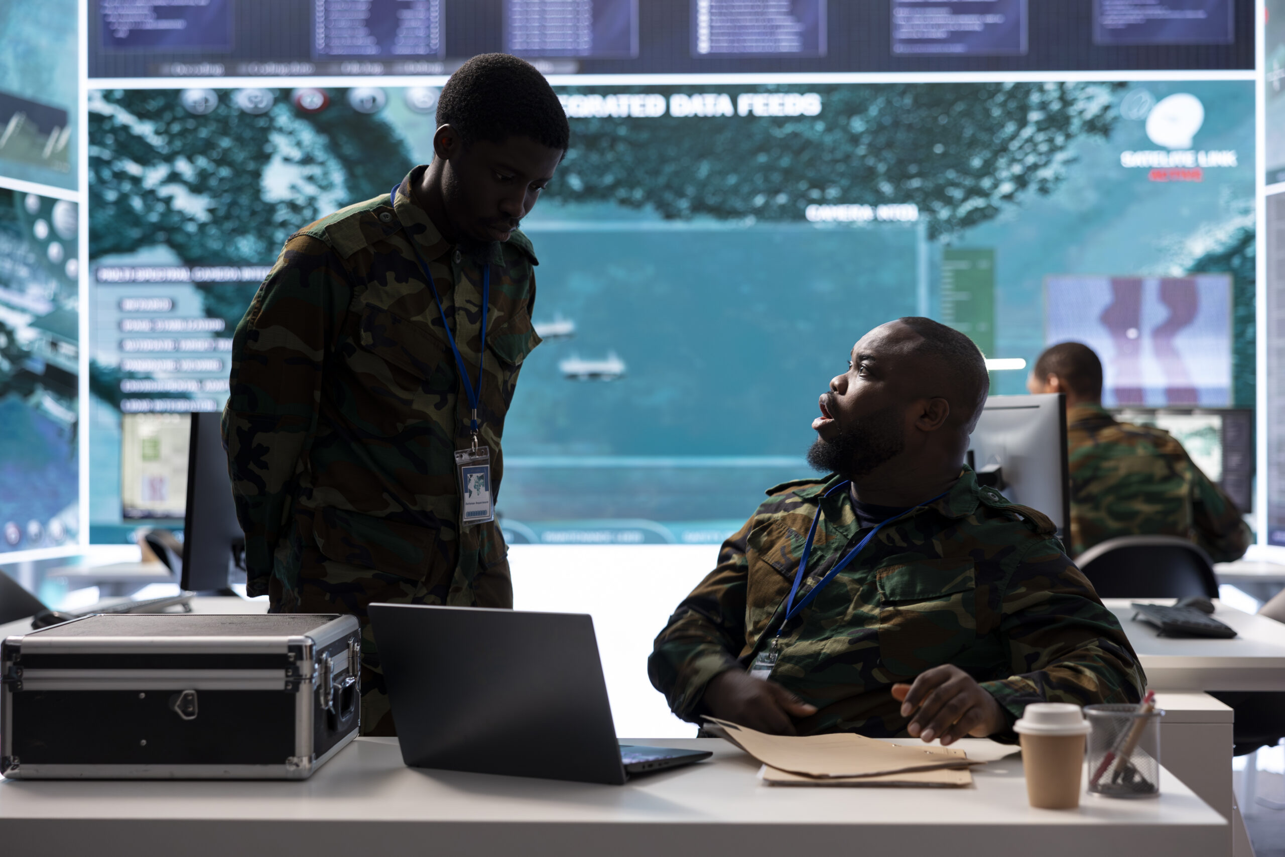 Soldiers team examining real time satellite data and details from old mission files, classified information to support new field operations. Surveillance for security protocols in control room.
