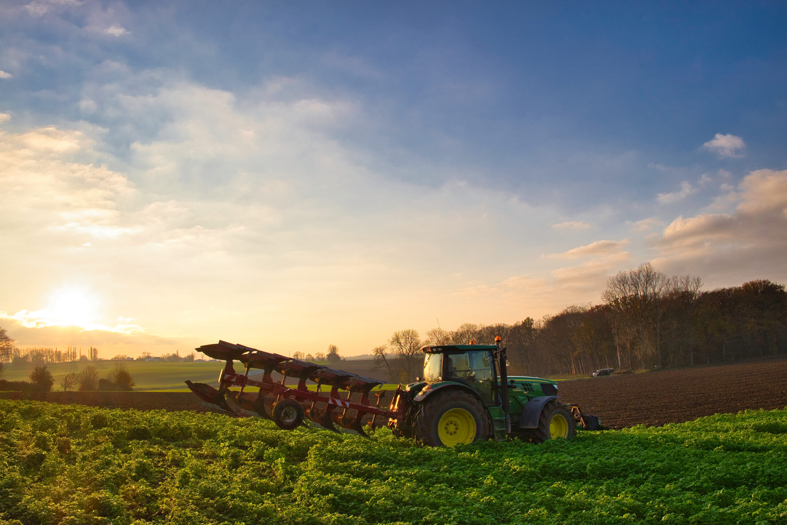 A tractor in the picturesque agricultural field at sunris, agriculture in Maransart, Lasne, Belgium